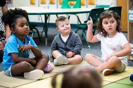 Preschool children sitting at circle time.